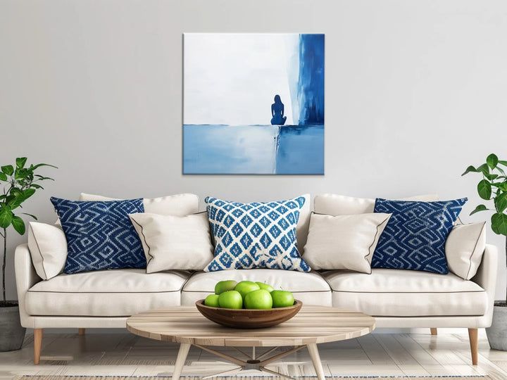 Contemplative Blue Solitary Figure Wall Art in Living Room